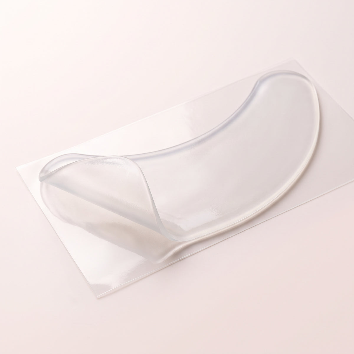 Clear reusable silicone neck patch on its backing